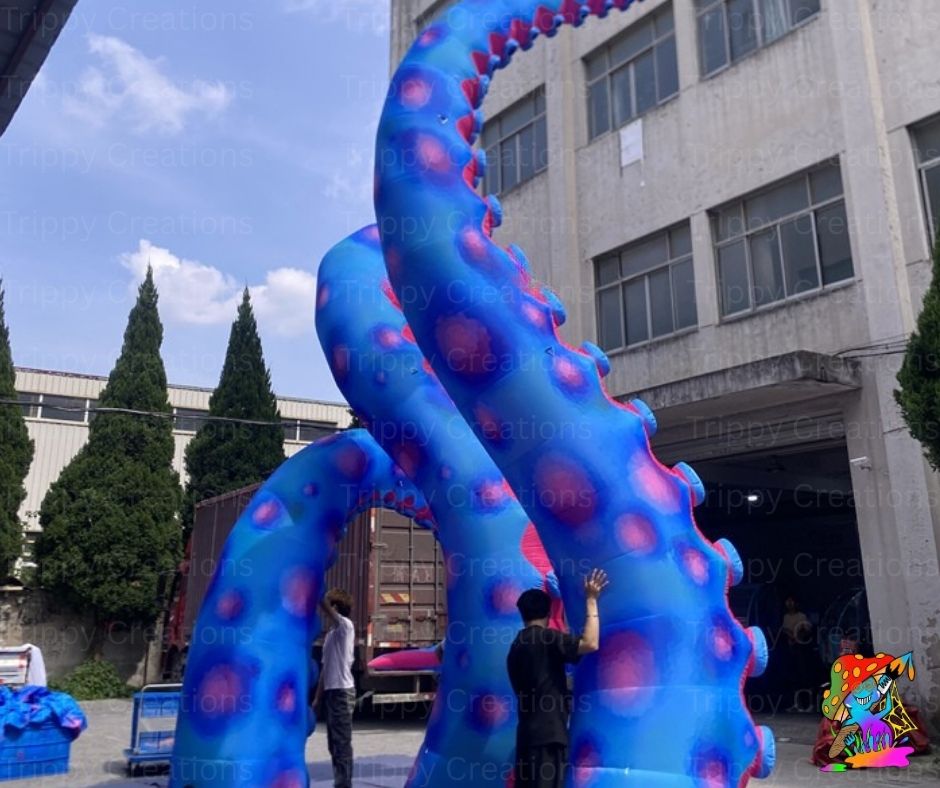 Large blue inflatable octopus sculpture in front of a building