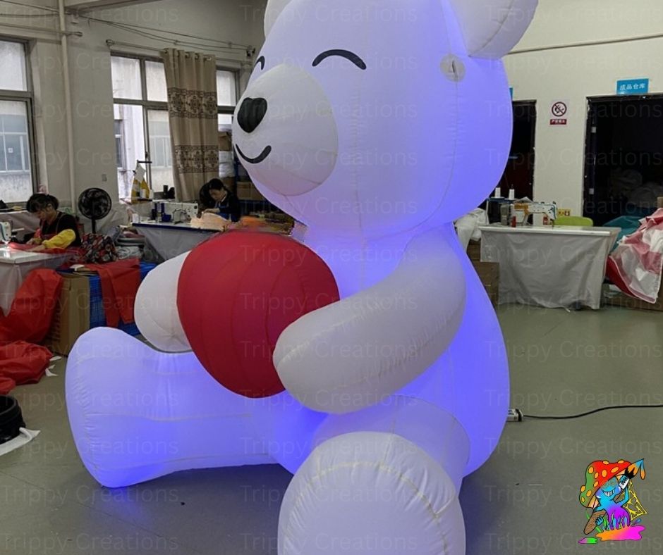 Inflatable polar bear with a red heart in an indoor setting