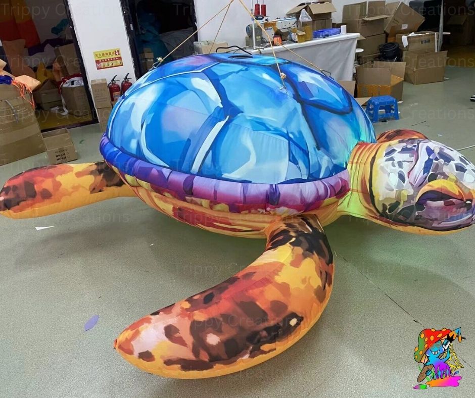 Colorful inflatable turtle model in a warehouse setting