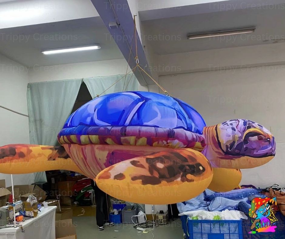 Inflatable sea turtle decoration hanging indoors with visible branding.