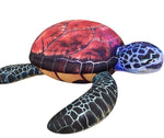 Colorful turtle prop with a red shell on a white background