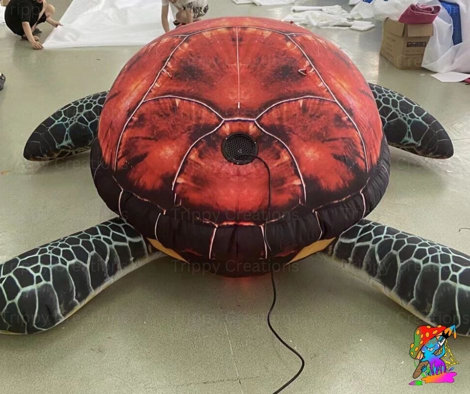 Inflatable turtle  on a floor with visible branding.