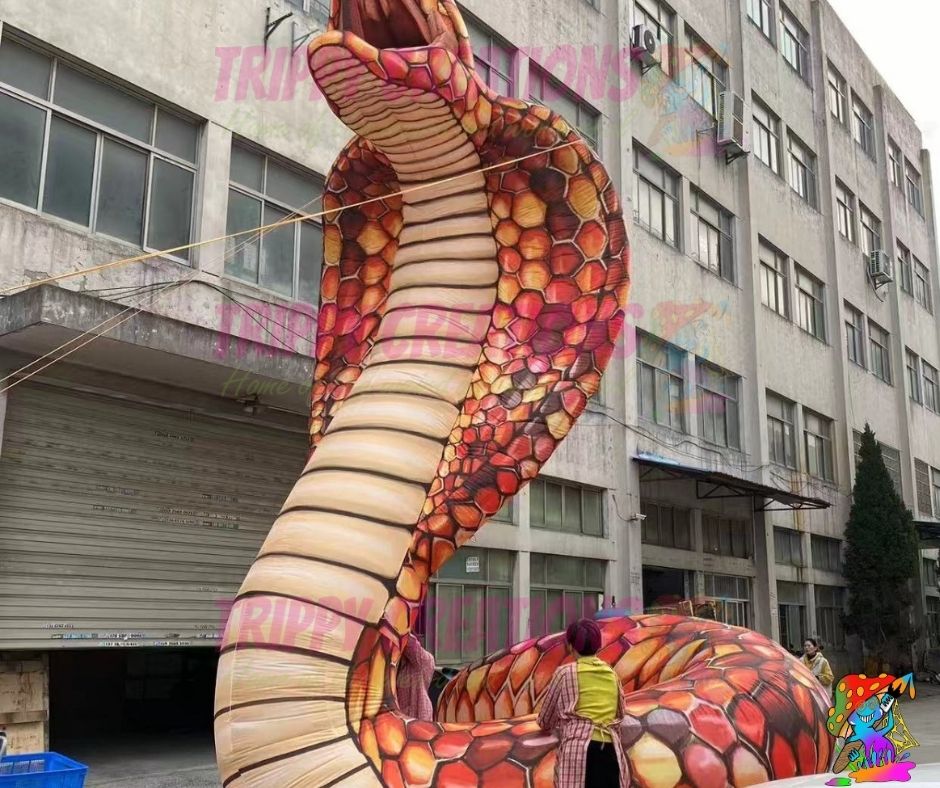 Large inflatable snake model in front of a building