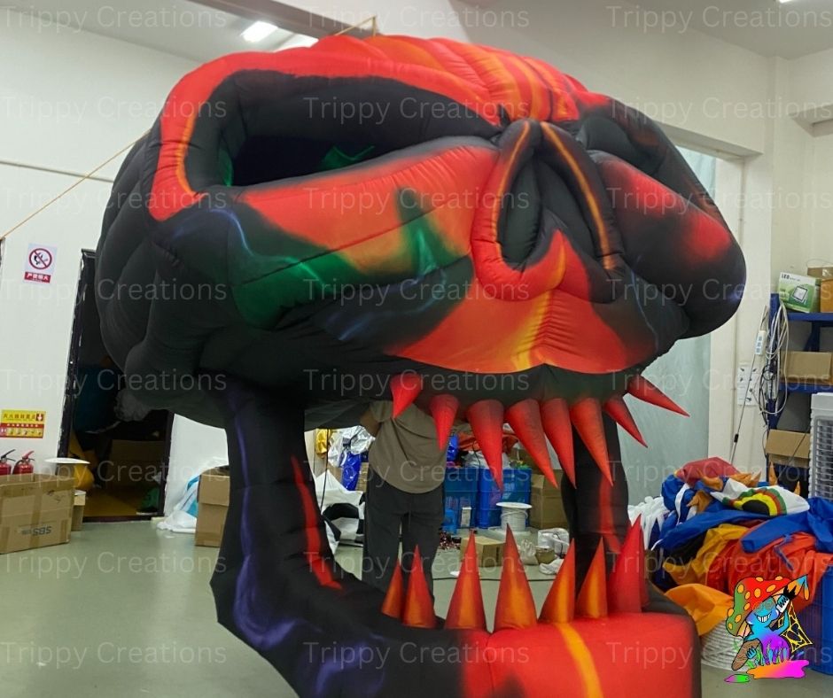 Scary red and black inflatable skull prop for Halloween venues
