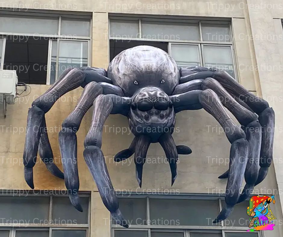 Inflatable spider prop set up indoors for a haunted house party scene with cobweb decorations.