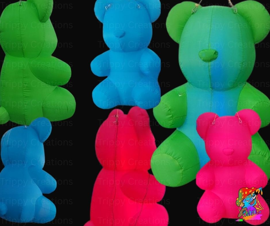 Colorful inflatable teddy bears arranged in a row on a black background.