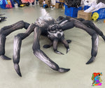 Inflatable spider with realistic leg structure and glowing LED effect, ideal for theatrical sets or outdoor event