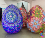 Colorful mandala-patterned eggs on a neutral background