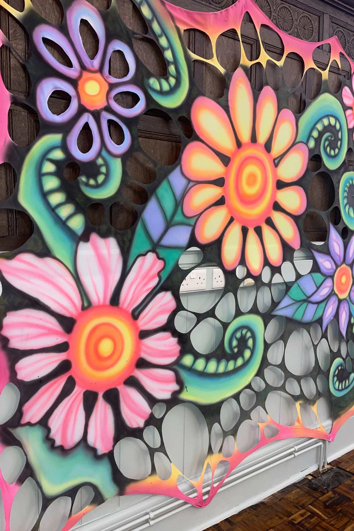 Trippy UV-reactive flower-power wall hanging for psychedelic events