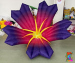 Inflatable flower with purple petals and yellow center 