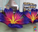Inflatable flower decorations with purple, pink, and yellow colors in a storage room.