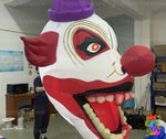 Halloween party setup featuring terrifying inflatable clown heads with bold colour and design.