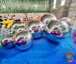 Silver reflective balls on a blue tarp with 'Trippy Creations' branding.
