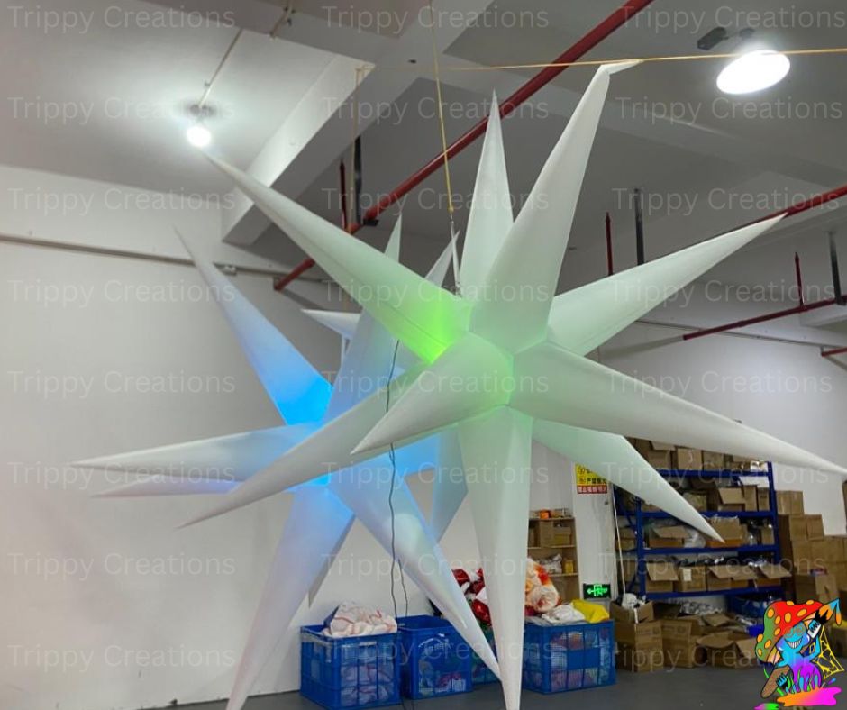 Large inflatable star-shaped decoration in a warehouse setting with 'Trippy Creations' branding.