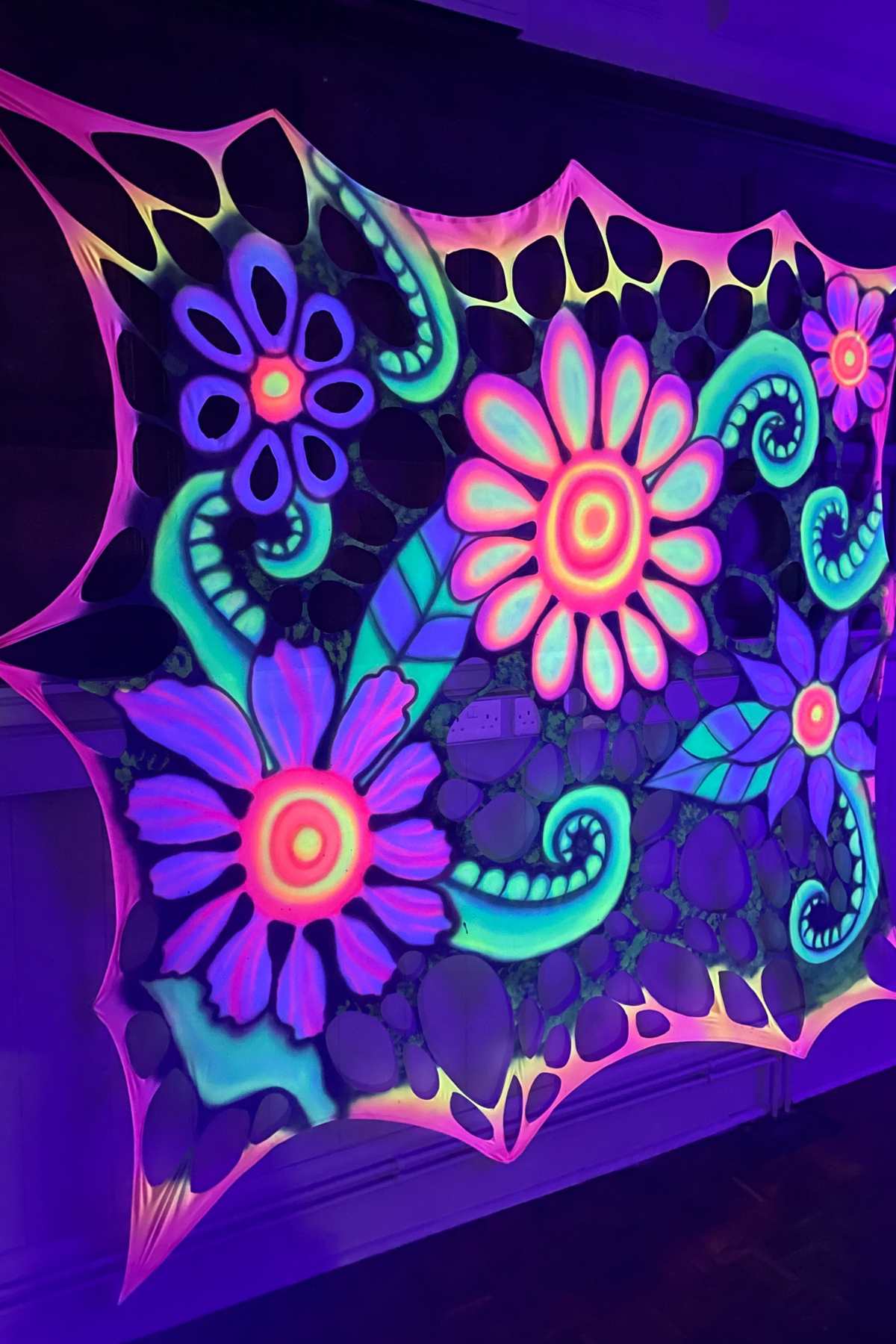 Trippy UV-reactive flower-power wall hanging for psychedelic events