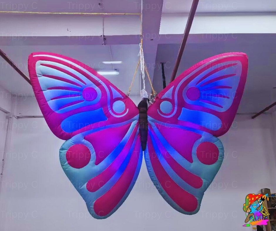 Large inflatable butterfly with pink and blue design hanging indoors.