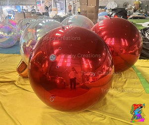Red inflatable bubbles on a yellow tarp with 'Trippy Creations' branding.
