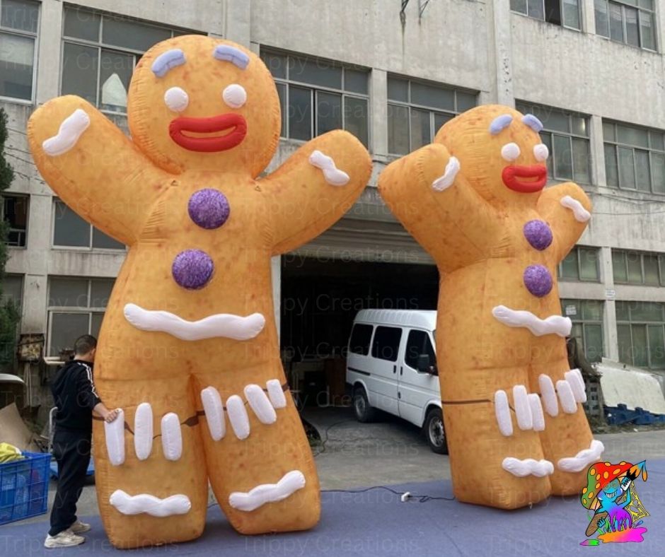 Two large inflatable gingerbread men in front of a building.