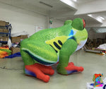 Colorful inflatable frog model in a warehouse setting with 'Trippy Creations' branding.