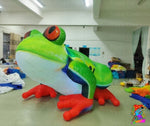 Inflatable frog decoration in a warehouse setting with 'Trippy Creations' branding.