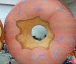 Inflatable donut with pink icing and blue sprinkles, branded 'Trippy Creations'.