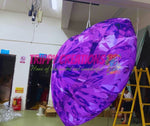 Purple inflatable diamond with 'Trippy Creations' branding in a workshop setting