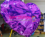 Large purple heart-shaped balloon with 'Trippy Creations' branding in a room with boxes and equipment.