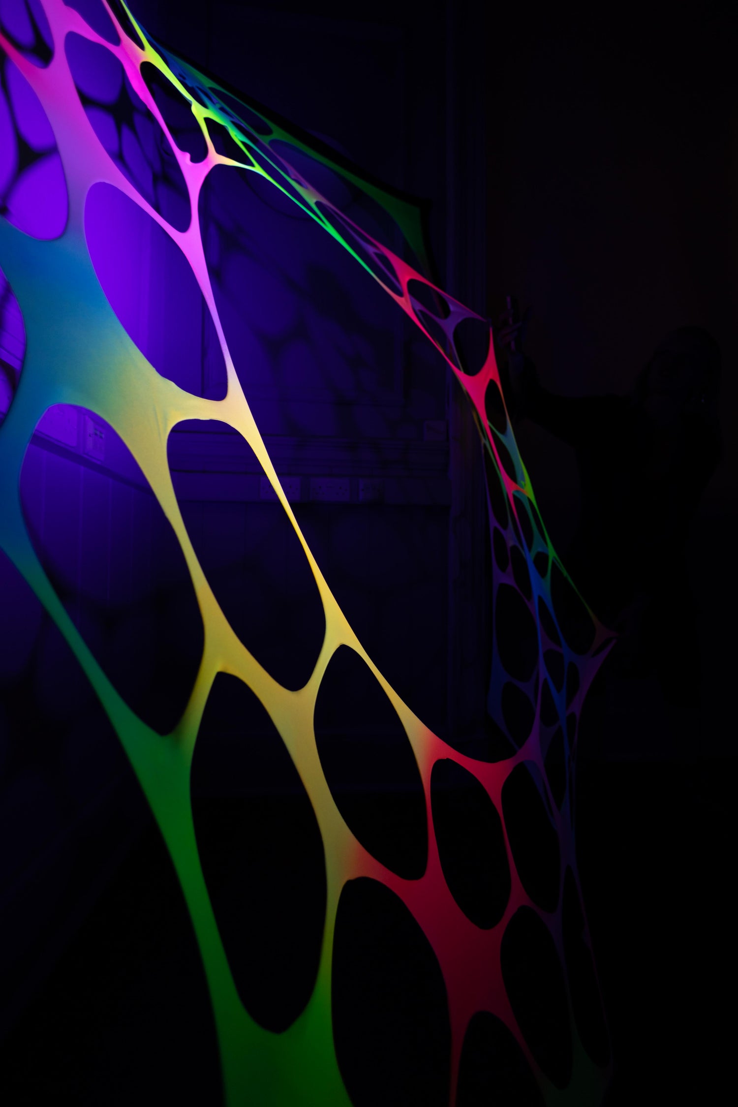 Psychedelic rainbow UV-reactive wall hanging for hire