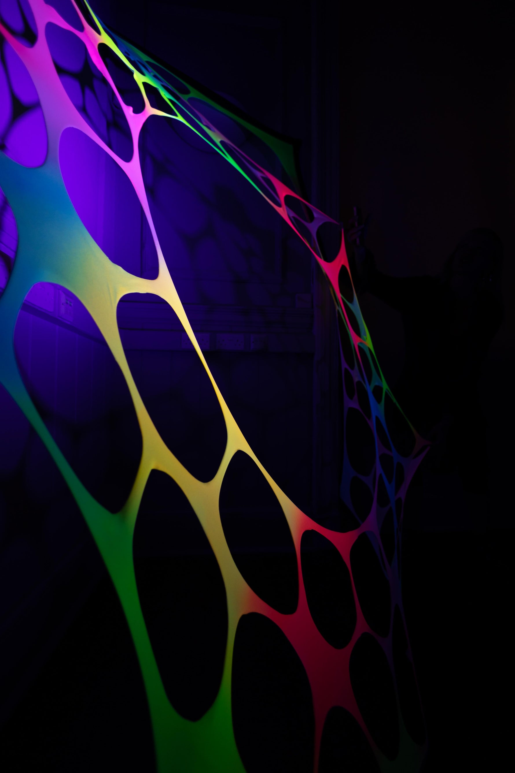 Psychedelic rainbow UV-reactive wall hanging for hire