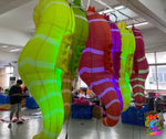 Colorful inflatable sea creature models on display in a workshop.