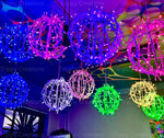 LED orb effect lights hanging from a ceiling at alternating heights