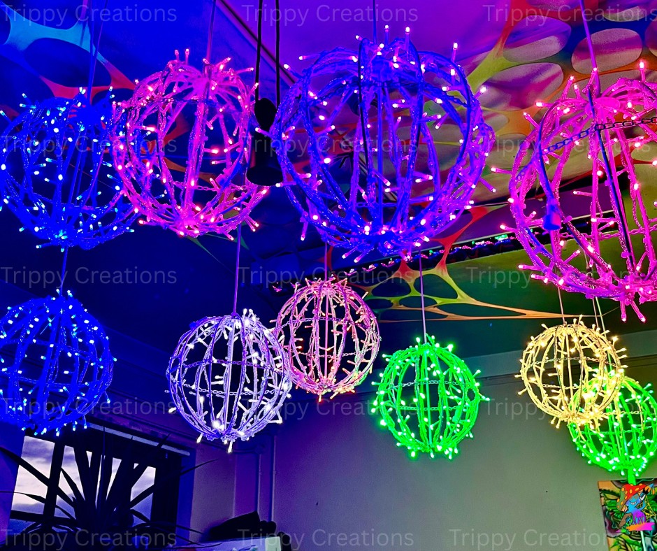 LED orb effect lights hanging from a ceiling at alternating heights