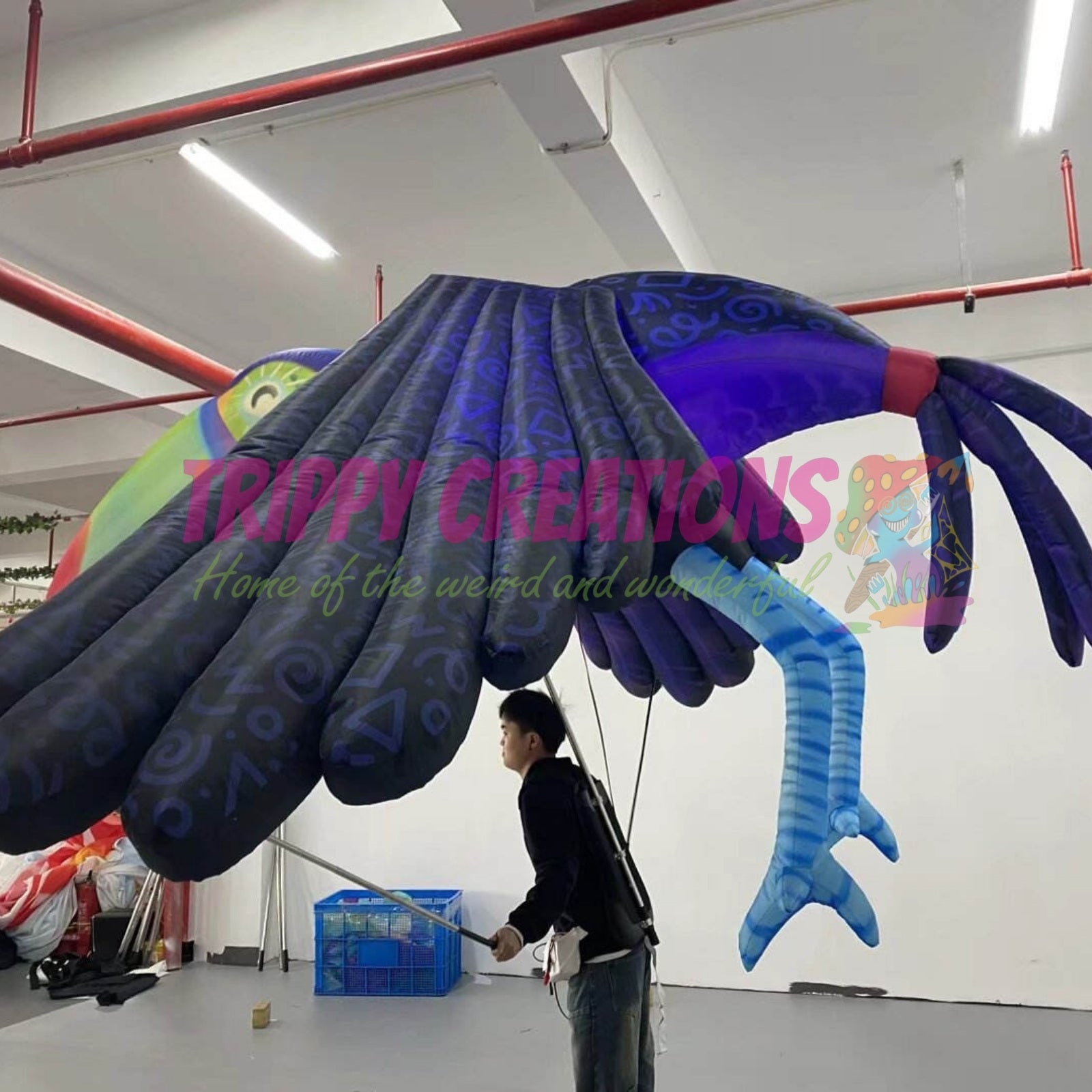 Oversized tropical parrot parade outfit attracting attention at a fun fair event