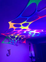 Vibrant UV-reactive rainbow wall decorations for hire
