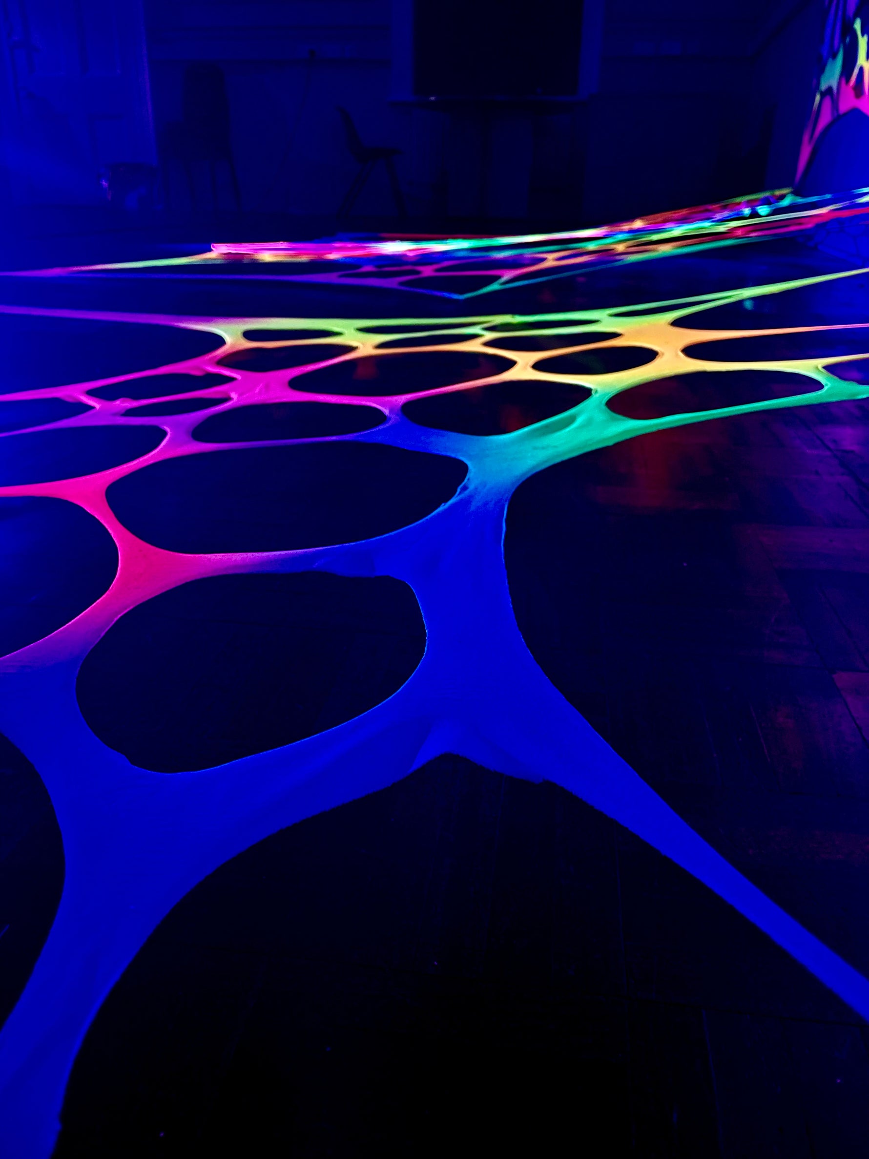 Hire UV-reactive rainbow wall decorations for raves and festivals