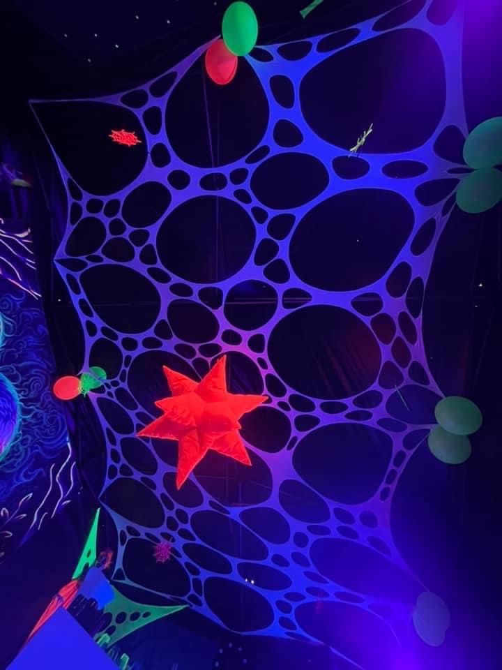 Glow-in-the-dark trippy tapestry for hire for raves