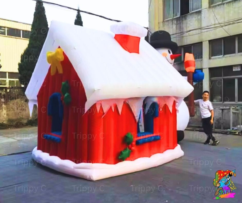 Inflatable snowman-shaped playhouse with a person standing nearby in an urban setting.