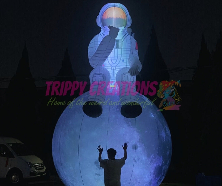inflatable astronaut sitting on moon prop for space themed events