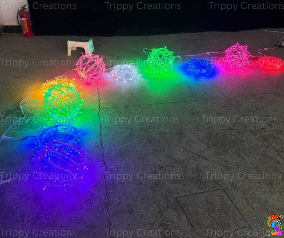 LED dangling orb lights glowing brightly in a dark immersive space