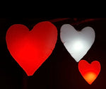 Colorful LED inflatable heart art installation lighting up a festival