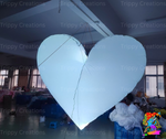 Elegant white LED love heart glowing at a wedding reception.
