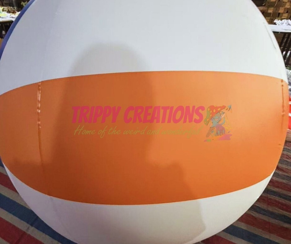 Large inflatable PVC volleyball used as entrance way decor for sports themed event