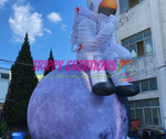 oversized astronaut sitting on moon inflatable party decor