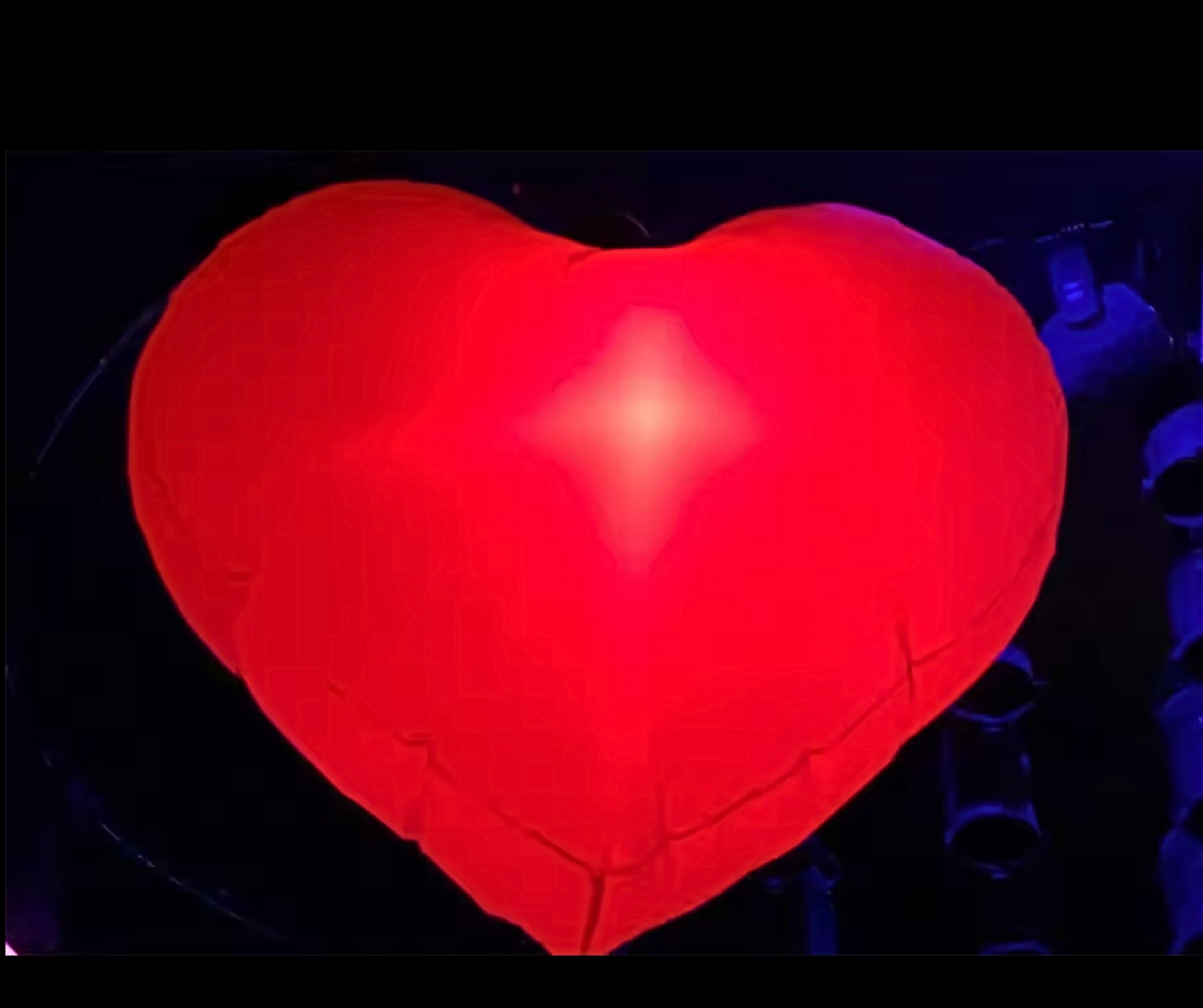 Vibrant red LED inflatable heart glowing for Valentine's Day decor.