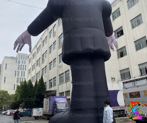 Inflatable figure in front of a building with 'Trippy Creations' branding.