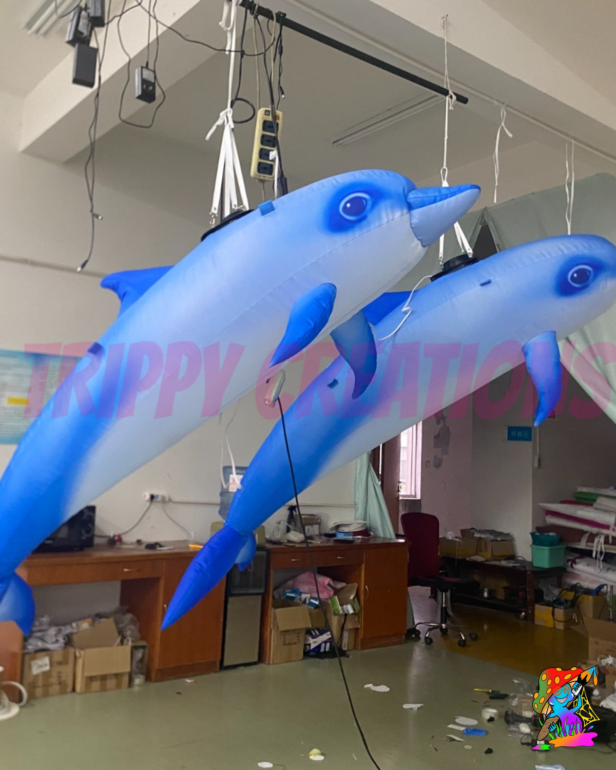     Inflatable dolphin ceiling decoration creating an immersive under the sea event environment.