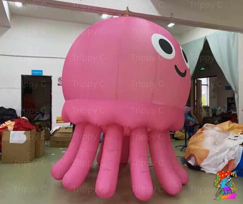 Inflatable pink octopus model in a warehouse setting