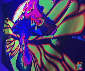 UV glowing butterfly wings on a large trippy mushroom wall hanging.
