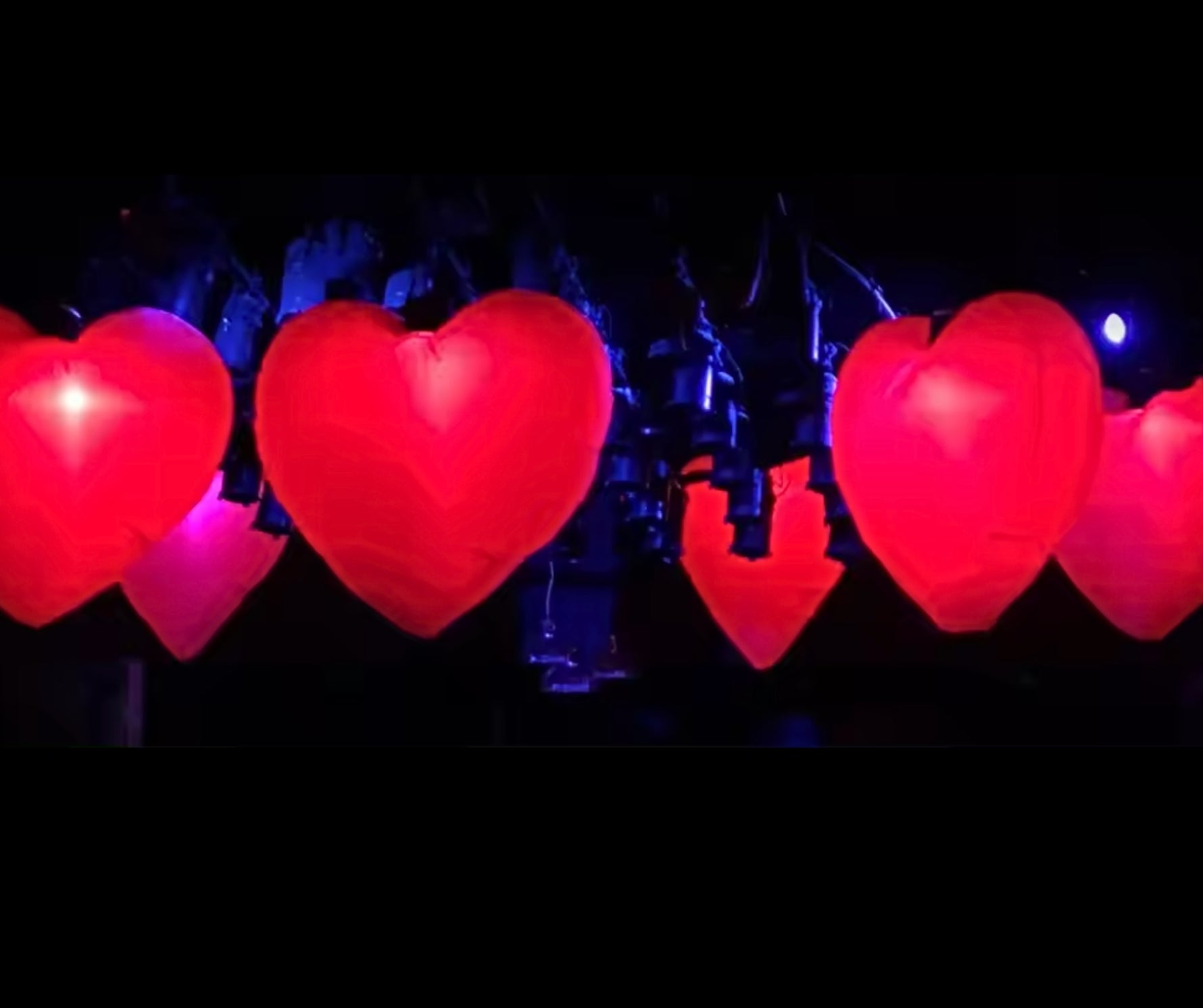 Large LED inflatable heart glowing beautifully at an outdoor event