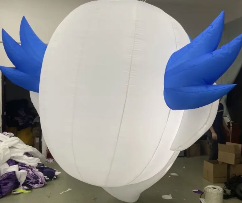 Pair of inflatable clown face decorations suspended outdoors, perfect for Halloween or horror-themed events